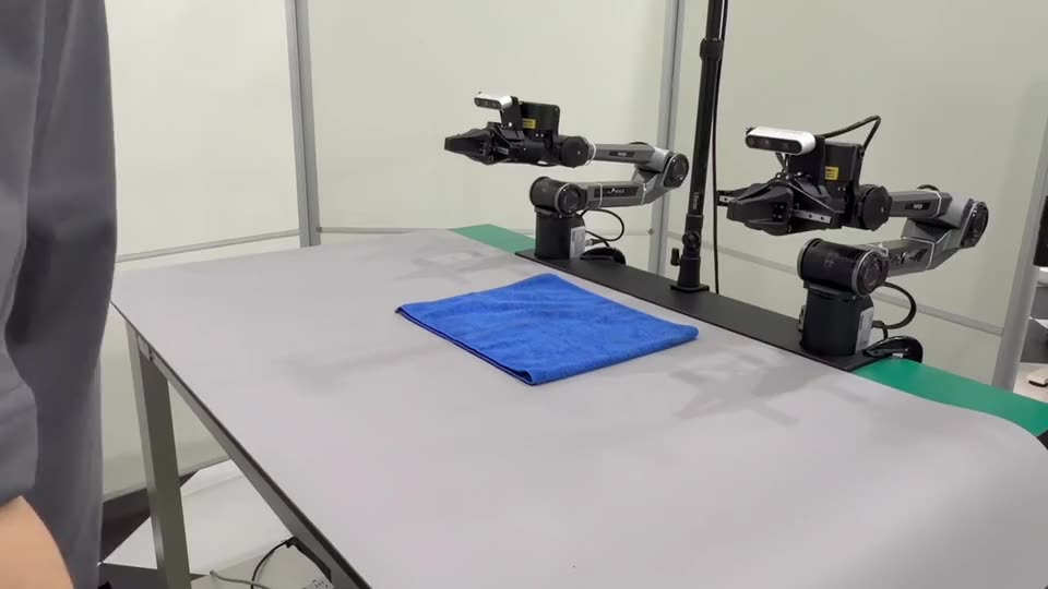 A blue towel laid flat, the two arms at rest behind it.